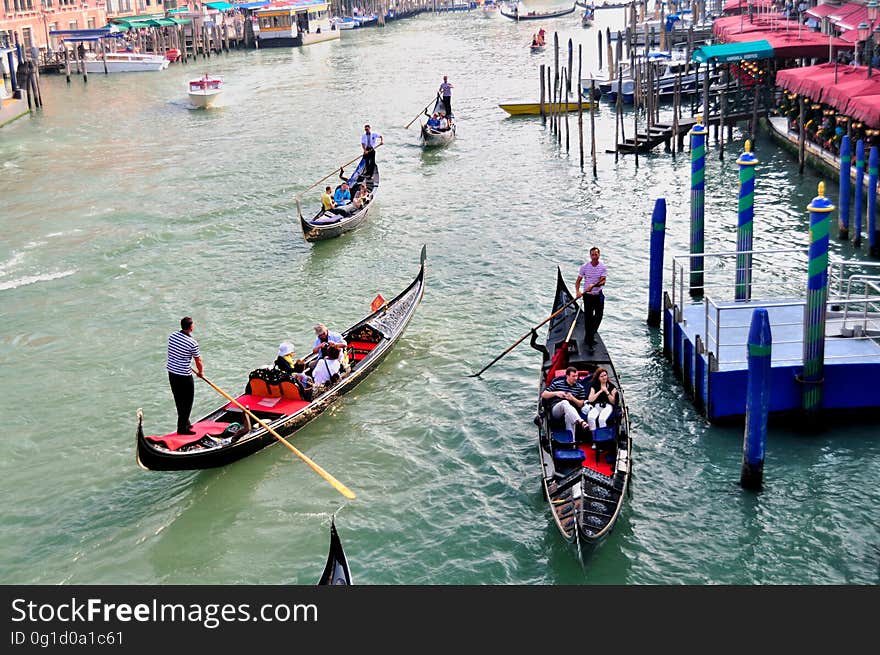 The water streets of Venice are canals which are navigated by gondolas and other small boats. During daylight hours the canals, bridges, and streets of Venice are full of tourists eager to experience the romance of this great travel destination. As night engulfs the town, tourists enjoy some fine dining at one of the many restaurants, leaving the waterways and streets quiet. The gondola is a traditional, flat-bottomed Venetian rowing boat, well suited to the conditions of the Venetian Lagoon. For centuries gondolas were once the chief means of transportation and most common watercraft within Venice. In modern times the iconic boats still have a role in public transport in the city, serving as ferries over the Grand Canal. They are also used in special regattas &#x28;rowing races&#x29; held amongst gondoliers. Their main role, however, is to carry tourists on rides throughout the canals. Gondolas are hand made using 8 different types of wood &#x28;fir, oak, cherry, walnut, elm, mahogany, larch and lime&#x29; and are composed of 280 pieces. The oars are made of beech wood. The left side of the gondola is longer than the right side. This asymmetry causes the gondola to resist the tendency to turn toward the left at the forward stroke. The water streets of Venice are canals which are navigated by gondolas and other small boats. During daylight hours the canals, bridges, and streets of Venice are full of tourists eager to experience the romance of this great travel destination. As night engulfs the town, tourists enjoy some fine dining at one of the many restaurants, leaving the waterways and streets quiet. The gondola is a traditional, flat-bottomed Venetian rowing boat, well suited to the conditions of the Venetian Lagoon. For centuries gondolas were once the chief means of transportation and most common watercraft within Venice. In modern times the iconic boats still have a role in public transport in the city, serving as ferries over the Grand Canal. They are also used in special regattas &#x28;rowing races&#x29; held amongst gondoliers. Their main role, however, is to carry tourists on rides throughout the canals. Gondolas are hand made using 8 different types of wood &#x28;fir, oak, cherry, walnut, elm, mahogany, larch and lime&#x29; and are composed of 280 pieces. The oars are made of beech wood. The left side of the gondola is longer than the right side. This asymmetry causes the gondola to resist the tendency to turn toward the left at the forward stroke.