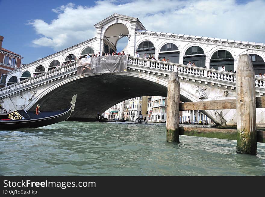 The water streets of Venice are canals which are navigated by gondolas and other small boats. During daylight hours the canals, bridges, and streets of Venice are full of tourists eager to experience the romance of this great travel destination. As night engulfs the town, tourists enjoy some fine dining at one of the many restaurants, leaving the waterways and streets quiet. The gondola is a traditional, flat-bottomed Venetian rowing boat, well suited to the conditions of the Venetian Lagoon. For centuries gondolas were once the chief means of transportation and most common watercraft within Venice. In modern times the iconic boats still have a role in public transport in the city, serving as ferries over the Grand Canal. They are also used in special regattas &#x28;rowing races&#x29; held amongst gondoliers. Their main role, however, is to carry tourists on rides throughout the canals. Gondolas are hand made using 8 different types of wood &#x28;fir, oak, cherry, walnut, elm, mahogany, larch and lime&#x29; and are composed of 280 pieces. The oars are made of beech wood. The left side of the gondola is longer than the right side. This asymmetry causes the gondola to resist the tendency to turn toward the left at the forward stroke. The water streets of Venice are canals which are navigated by gondolas and other small boats. During daylight hours the canals, bridges, and streets of Venice are full of tourists eager to experience the romance of this great travel destination. As night engulfs the town, tourists enjoy some fine dining at one of the many restaurants, leaving the waterways and streets quiet. The gondola is a traditional, flat-bottomed Venetian rowing boat, well suited to the conditions of the Venetian Lagoon. For centuries gondolas were once the chief means of transportation and most common watercraft within Venice. In modern times the iconic boats still have a role in public transport in the city, serving as ferries over the Grand Canal. They are also used in special regattas &#x28;rowing races&#x29; held amongst gondoliers. Their main role, however, is to carry tourists on rides throughout the canals. Gondolas are hand made using 8 different types of wood &#x28;fir, oak, cherry, walnut, elm, mahogany, larch and lime&#x29; and are composed of 280 pieces. The oars are made of beech wood. The left side of the gondola is longer than the right side. This asymmetry causes the gondola to resist the tendency to turn toward the left at the forward stroke.