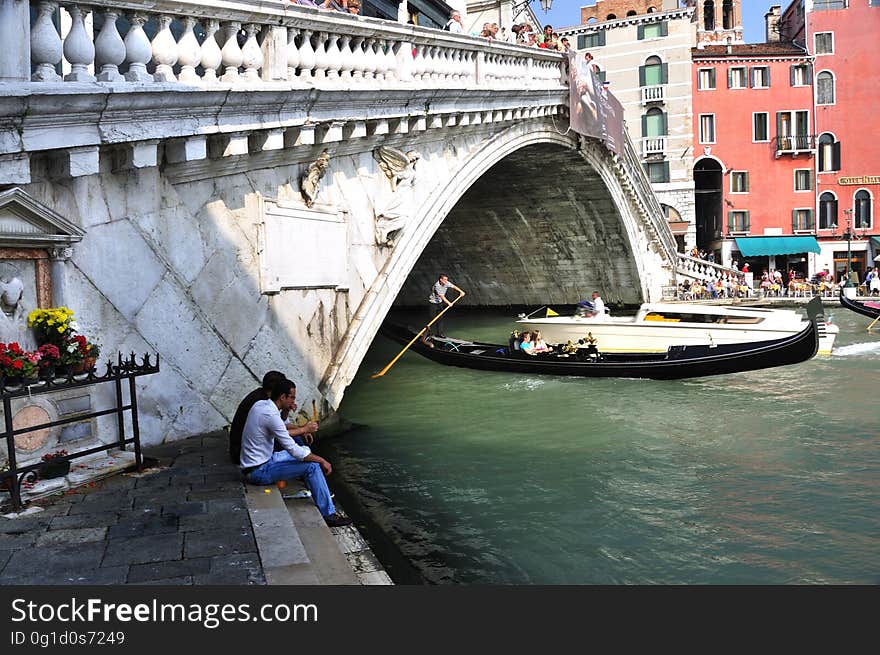 The water streets of Venice are canals which are navigated by gondolas and other small boats. During daylight hours the canals, bridges, and streets of Venice are full of tourists eager to experience the romance of this great travel destination. As night engulfs the town, tourists enjoy some fine dining at one of the many restaurants, leaving the waterways and streets quiet. The gondola is a traditional, flat-bottomed Venetian rowing boat, well suited to the conditions of the Venetian Lagoon. For centuries gondolas were once the chief means of transportation and most common watercraft within Venice. In modern times the iconic boats still have a role in public transport in the city, serving as ferries over the Grand Canal. They are also used in special regattas &#x28;rowing races&#x29; held amongst gondoliers. Their main role, however, is to carry tourists on rides throughout the canals. Gondolas are hand made using 8 different types of wood &#x28;fir, oak, cherry, walnut, elm, mahogany, larch and lime&#x29; and are composed of 280 pieces. The oars are made of beech wood. The left side of the gondola is longer than the right side. This asymmetry causes the gondola to resist the tendency to turn toward the left at the forward stroke. The water streets of Venice are canals which are navigated by gondolas and other small boats. During daylight hours the canals, bridges, and streets of Venice are full of tourists eager to experience the romance of this great travel destination. As night engulfs the town, tourists enjoy some fine dining at one of the many restaurants, leaving the waterways and streets quiet. The gondola is a traditional, flat-bottomed Venetian rowing boat, well suited to the conditions of the Venetian Lagoon. For centuries gondolas were once the chief means of transportation and most common watercraft within Venice. In modern times the iconic boats still have a role in public transport in the city, serving as ferries over the Grand Canal. They are also used in special regattas &#x28;rowing races&#x29; held amongst gondoliers. Their main role, however, is to carry tourists on rides throughout the canals. Gondolas are hand made using 8 different types of wood &#x28;fir, oak, cherry, walnut, elm, mahogany, larch and lime&#x29; and are composed of 280 pieces. The oars are made of beech wood. The left side of the gondola is longer than the right side. This asymmetry causes the gondola to resist the tendency to turn toward the left at the forward stroke.