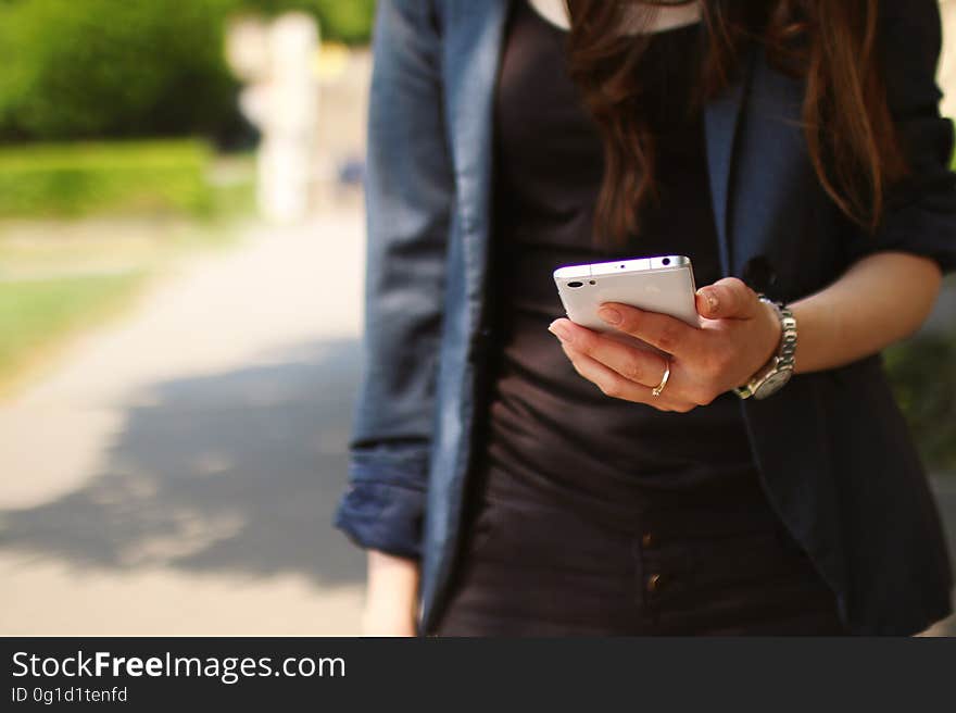 Woman Holding White Smartphone