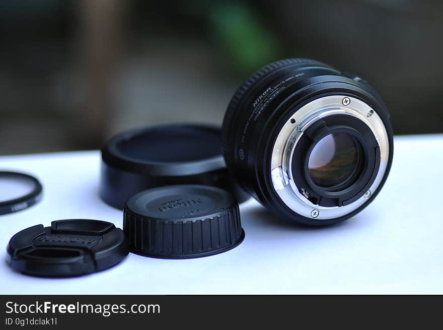 A camera lens with lens cap, hood for contre-jour and filters. A camera lens with lens cap, hood for contre-jour and filters.