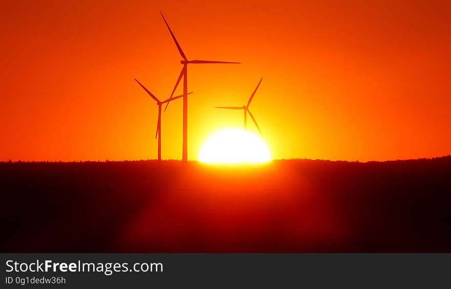 Silhouette of Wind Turbines at Sunset