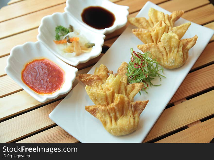 Crispy dumpling appetizer with dipping sauce. Crispy dumpling appetizer with dipping sauce.