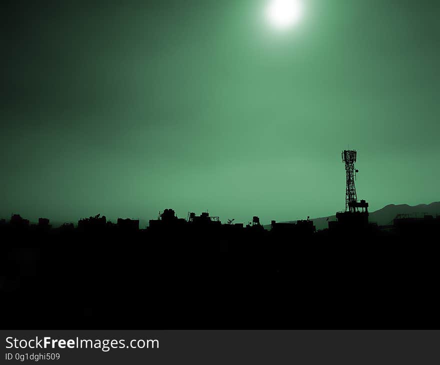 A landscape with silhouettes of buildings and the sky above. A landscape with silhouettes of buildings and the sky above.