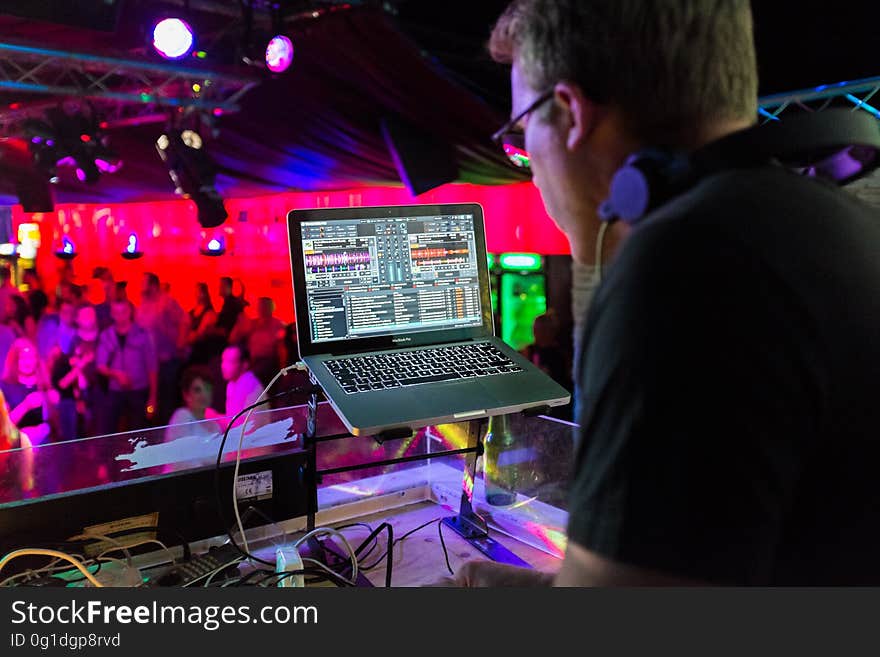 A DJ playing for the crowd in a club.