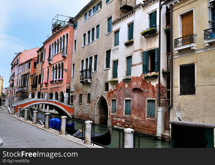 The water streets of Venice are canals which are navigated by gondolas and other small boats. During daylight hours the canals, bridges, and streets of Venice are full of tourists eager to experience the romance of this great travel destination. As night engulfs the town, tourists enjoy some fine dining at one of the many restaurants, leaving the waterways and streets quiet. The gondola is a traditional, flat-bottomed Venetian rowing boat, well suited to the conditions of the Venetian Lagoon. For centuries gondolas were once the chief means of transportation and most common watercraft within Venice. In modern times the iconic boats still have a role in public transport in the city, serving as ferries over the Grand Canal. They are also used in special regattas &#x28;rowing races&#x29; held amongst gondoliers. Their main role, however, is to carry tourists on rides throughout the canals. Gondolas are hand made using 8 different types of wood &#x28;fir, oak, cherry, walnut, elm, mahogany, larch and lime&#x29; and are composed of 280 pieces. The oars are made of beech wood. The left side of the gondola is longer than the right side. This asymmetry causes the gondola to resist the tendency to turn toward the left at the forward stroke. The water streets of Venice are canals which are navigated by gondolas and other small boats. During daylight hours the canals, bridges, and streets of Venice are full of tourists eager to experience the romance of this great travel destination. As night engulfs the town, tourists enjoy some fine dining at one of the many restaurants, leaving the waterways and streets quiet. The gondola is a traditional, flat-bottomed Venetian rowing boat, well suited to the conditions of the Venetian Lagoon. For centuries gondolas were once the chief means of transportation and most common watercraft within Venice. In modern times the iconic boats still have a role in public transport in the city, serving as ferries over the Grand Canal. They are also used in special regattas &#x28;rowing races&#x29; held amongst gondoliers. Their main role, however, is to carry tourists on rides throughout the canals. Gondolas are hand made using 8 different types of wood &#x28;fir, oak, cherry, walnut, elm, mahogany, larch and lime&#x29; and are composed of 280 pieces. The oars are made of beech wood. The left side of the gondola is longer than the right side. This asymmetry causes the gondola to resist the tendency to turn toward the left at the forward stroke.