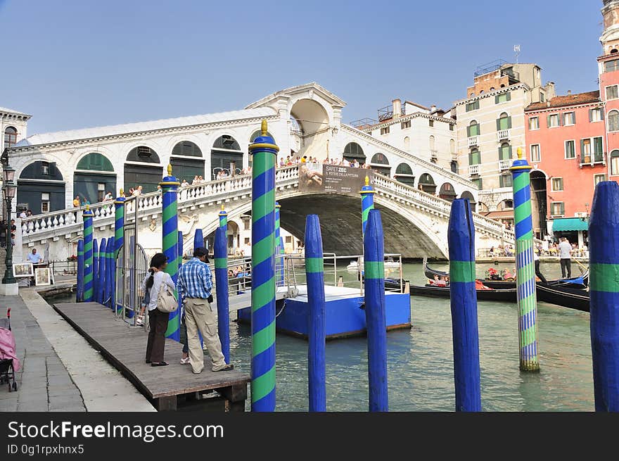 The water streets of Venice are canals which are navigated by gondolas and other small boats. During daylight hours the canals, bridges, and streets of Venice are full of tourists eager to experience the romance of this great travel destination. As night engulfs the town, tourists enjoy some fine dining at one of the many restaurants, leaving the waterways and streets quiet. The gondola is a traditional, flat-bottomed Venetian rowing boat, well suited to the conditions of the Venetian Lagoon. For centuries gondolas were once the chief means of transportation and most common watercraft within Venice. In modern times the iconic boats still have a role in public transport in the city, serving as ferries over the Grand Canal. They are also used in special regattas &#x28;rowing races&#x29; held amongst gondoliers. Their main role, however, is to carry tourists on rides throughout the canals. Gondolas are hand made using 8 different types of wood &#x28;fir, oak, cherry, walnut, elm, mahogany, larch and lime&#x29; and are composed of 280 pieces. The oars are made of beech wood. The left side of the gondola is longer than the right side. This asymmetry causes the gondola to resist the tendency to turn toward the left at the forward stroke. The water streets of Venice are canals which are navigated by gondolas and other small boats. During daylight hours the canals, bridges, and streets of Venice are full of tourists eager to experience the romance of this great travel destination. As night engulfs the town, tourists enjoy some fine dining at one of the many restaurants, leaving the waterways and streets quiet. The gondola is a traditional, flat-bottomed Venetian rowing boat, well suited to the conditions of the Venetian Lagoon. For centuries gondolas were once the chief means of transportation and most common watercraft within Venice. In modern times the iconic boats still have a role in public transport in the city, serving as ferries over the Grand Canal. They are also used in special regattas &#x28;rowing races&#x29; held amongst gondoliers. Their main role, however, is to carry tourists on rides throughout the canals. Gondolas are hand made using 8 different types of wood &#x28;fir, oak, cherry, walnut, elm, mahogany, larch and lime&#x29; and are composed of 280 pieces. The oars are made of beech wood. The left side of the gondola is longer than the right side. This asymmetry causes the gondola to resist the tendency to turn toward the left at the forward stroke.