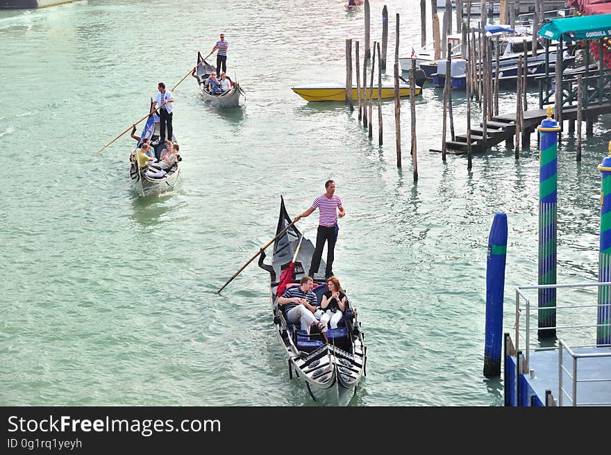 The water streets of Venice are canals which are navigated by gondolas and other small boats. During daylight hours the canals, bridges, and streets of Venice are full of tourists eager to experience the romance of this great travel destination. As night engulfs the town, tourists enjoy some fine dining at one of the many restaurants, leaving the waterways and streets quiet. The gondola is a traditional, flat-bottomed Venetian rowing boat, well suited to the conditions of the Venetian Lagoon. For centuries gondolas were once the chief means of transportation and most common watercraft within Venice. In modern times the iconic boats still have a role in public transport in the city, serving as ferries over the Grand Canal. They are also used in special regattas &#x28;rowing races&#x29; held amongst gondoliers. Their main role, however, is to carry tourists on rides throughout the canals. Gondolas are hand made using 8 different types of wood &#x28;fir, oak, cherry, walnut, elm, mahogany, larch and lime&#x29; and are composed of 280 pieces. The oars are made of beech wood. The left side of the gondola is longer than the right side. This asymmetry causes the gondola to resist the tendency to turn toward the left at the forward stroke. The water streets of Venice are canals which are navigated by gondolas and other small boats. During daylight hours the canals, bridges, and streets of Venice are full of tourists eager to experience the romance of this great travel destination. As night engulfs the town, tourists enjoy some fine dining at one of the many restaurants, leaving the waterways and streets quiet. The gondola is a traditional, flat-bottomed Venetian rowing boat, well suited to the conditions of the Venetian Lagoon. For centuries gondolas were once the chief means of transportation and most common watercraft within Venice. In modern times the iconic boats still have a role in public transport in the city, serving as ferries over the Grand Canal. They are also used in special regattas &#x28;rowing races&#x29; held amongst gondoliers. Their main role, however, is to carry tourists on rides throughout the canals. Gondolas are hand made using 8 different types of wood &#x28;fir, oak, cherry, walnut, elm, mahogany, larch and lime&#x29; and are composed of 280 pieces. The oars are made of beech wood. The left side of the gondola is longer than the right side. This asymmetry causes the gondola to resist the tendency to turn toward the left at the forward stroke.