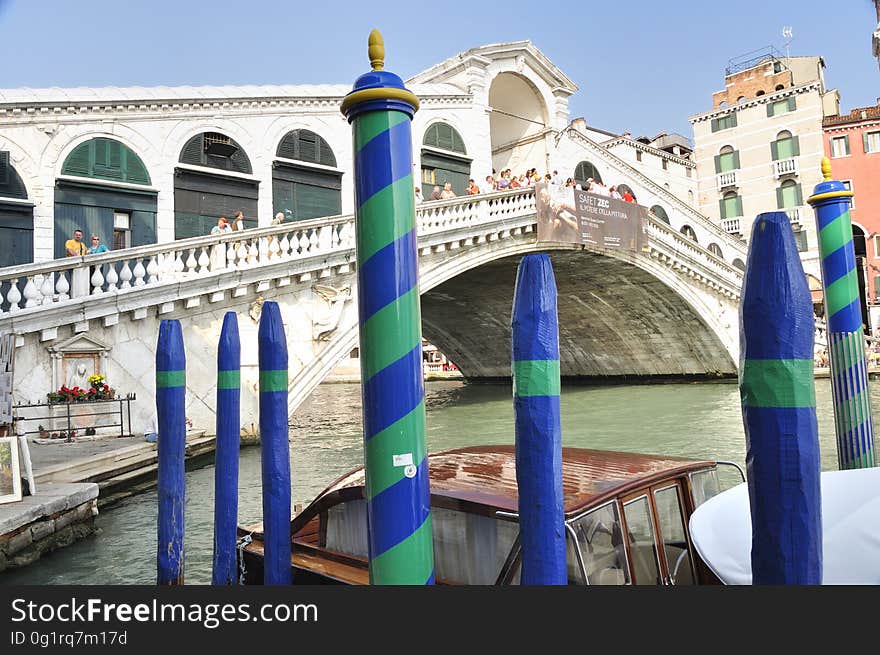 The water streets of Venice are canals which are navigated by gondolas and other small boats. During daylight hours the canals, bridges, and streets of Venice are full of tourists eager to experience the romance of this great travel destination. As night engulfs the town, tourists enjoy some fine dining at one of the many restaurants, leaving the waterways and streets quiet. The gondola is a traditional, flat-bottomed Venetian rowing boat, well suited to the conditions of the Venetian Lagoon. For centuries gondolas were once the chief means of transportation and most common watercraft within Venice. In modern times the iconic boats still have a role in public transport in the city, serving as ferries over the Grand Canal. They are also used in special regattas &#x28;rowing races&#x29; held amongst gondoliers. Their main role, however, is to carry tourists on rides throughout the canals. Gondolas are hand made using 8 different types of wood &#x28;fir, oak, cherry, walnut, elm, mahogany, larch and lime&#x29; and are composed of 280 pieces. The oars are made of beech wood. The left side of the gondola is longer than the right side. This asymmetry causes the gondola to resist the tendency to turn toward the left at the forward stroke. The water streets of Venice are canals which are navigated by gondolas and other small boats. During daylight hours the canals, bridges, and streets of Venice are full of tourists eager to experience the romance of this great travel destination. As night engulfs the town, tourists enjoy some fine dining at one of the many restaurants, leaving the waterways and streets quiet. The gondola is a traditional, flat-bottomed Venetian rowing boat, well suited to the conditions of the Venetian Lagoon. For centuries gondolas were once the chief means of transportation and most common watercraft within Venice. In modern times the iconic boats still have a role in public transport in the city, serving as ferries over the Grand Canal. They are also used in special regattas &#x28;rowing races&#x29; held amongst gondoliers. Their main role, however, is to carry tourists on rides throughout the canals. Gondolas are hand made using 8 different types of wood &#x28;fir, oak, cherry, walnut, elm, mahogany, larch and lime&#x29; and are composed of 280 pieces. The oars are made of beech wood. The left side of the gondola is longer than the right side. This asymmetry causes the gondola to resist the tendency to turn toward the left at the forward stroke.