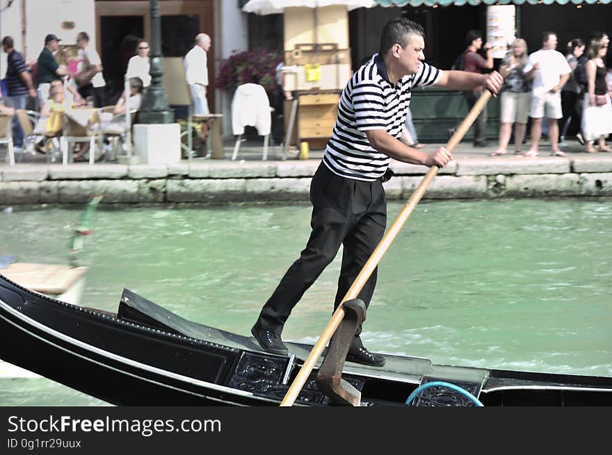 The water streets of Venice are canals which are navigated by gondolas and other small boats. During daylight hours the canals, bridges, and streets of Venice are full of tourists eager to experience the romance of this great travel destination. As night engulfs the town, tourists enjoy some fine dining at one of the many restaurants, leaving the waterways and streets quiet. The gondola is a traditional, flat-bottomed Venetian rowing boat, well suited to the conditions of the Venetian Lagoon. For centuries gondolas were once the chief means of transportation and most common watercraft within Venice. In modern times the iconic boats still have a role in public transport in the city, serving as ferries over the Grand Canal. They are also used in special regattas &#x28;rowing races&#x29; held amongst gondoliers. Their main role, however, is to carry tourists on rides throughout the canals. Gondolas are hand made using 8 different types of wood &#x28;fir, oak, cherry, walnut, elm, mahogany, larch and lime&#x29; and are composed of 280 pieces. The oars are made of beech wood. The left side of the gondola is longer than the right side. This asymmetry causes the gondola to resist the tendency to turn toward the left at the forward stroke. The water streets of Venice are canals which are navigated by gondolas and other small boats. During daylight hours the canals, bridges, and streets of Venice are full of tourists eager to experience the romance of this great travel destination. As night engulfs the town, tourists enjoy some fine dining at one of the many restaurants, leaving the waterways and streets quiet. The gondola is a traditional, flat-bottomed Venetian rowing boat, well suited to the conditions of the Venetian Lagoon. For centuries gondolas were once the chief means of transportation and most common watercraft within Venice. In modern times the iconic boats still have a role in public transport in the city, serving as ferries over the Grand Canal. They are also used in special regattas &#x28;rowing races&#x29; held amongst gondoliers. Their main role, however, is to carry tourists on rides throughout the canals. Gondolas are hand made using 8 different types of wood &#x28;fir, oak, cherry, walnut, elm, mahogany, larch and lime&#x29; and are composed of 280 pieces. The oars are made of beech wood. The left side of the gondola is longer than the right side. This asymmetry causes the gondola to resist the tendency to turn toward the left at the forward stroke.