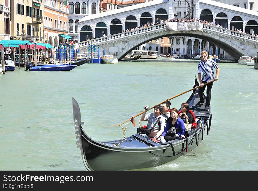 The water streets of Venice are canals which are navigated by gondolas and other small boats. During daylight hours the canals, bridges, and streets of Venice are full of tourists eager to experience the romance of this great travel destination. As night engulfs the town, tourists enjoy some fine dining at one of the many restaurants, leaving the waterways and streets quiet. The gondola is a traditional, flat-bottomed Venetian rowing boat, well suited to the conditions of the Venetian Lagoon. For centuries gondolas were once the chief means of transportation and most common watercraft within Venice. In modern times the iconic boats still have a role in public transport in the city, serving as ferries over the Grand Canal. They are also used in special regattas &#x28;rowing races&#x29; held amongst gondoliers. Their main role, however, is to carry tourists on rides throughout the canals. Gondolas are hand made using 8 different types of wood &#x28;fir, oak, cherry, walnut, elm, mahogany, larch and lime&#x29; and are composed of 280 pieces. The oars are made of beech wood. The left side of the gondola is longer than the right side. This asymmetry causes the gondola to resist the tendency to turn toward the left at the forward stroke. The water streets of Venice are canals which are navigated by gondolas and other small boats. During daylight hours the canals, bridges, and streets of Venice are full of tourists eager to experience the romance of this great travel destination. As night engulfs the town, tourists enjoy some fine dining at one of the many restaurants, leaving the waterways and streets quiet. The gondola is a traditional, flat-bottomed Venetian rowing boat, well suited to the conditions of the Venetian Lagoon. For centuries gondolas were once the chief means of transportation and most common watercraft within Venice. In modern times the iconic boats still have a role in public transport in the city, serving as ferries over the Grand Canal. They are also used in special regattas &#x28;rowing races&#x29; held amongst gondoliers. Their main role, however, is to carry tourists on rides throughout the canals. Gondolas are hand made using 8 different types of wood &#x28;fir, oak, cherry, walnut, elm, mahogany, larch and lime&#x29; and are composed of 280 pieces. The oars are made of beech wood. The left side of the gondola is longer than the right side. This asymmetry causes the gondola to resist the tendency to turn toward the left at the forward stroke.