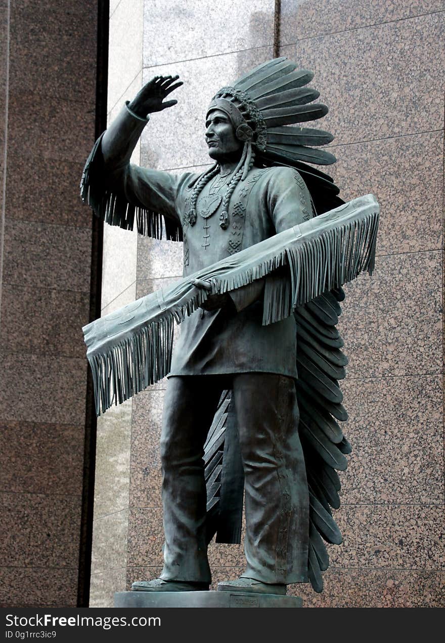 This statue is of Sitting Eagle or John Hunter is located on the corner of 7 Avenue and 6 Street SW in downtown Calgary, Alberta. This statue is of Sitting Eagle or John Hunter is located on the corner of 7 Avenue and 6 Street SW in downtown Calgary, Alberta.