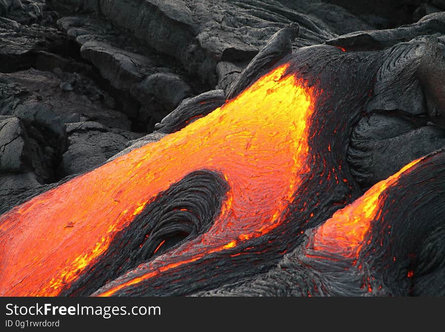 A molten lava flow coming down a mountain.