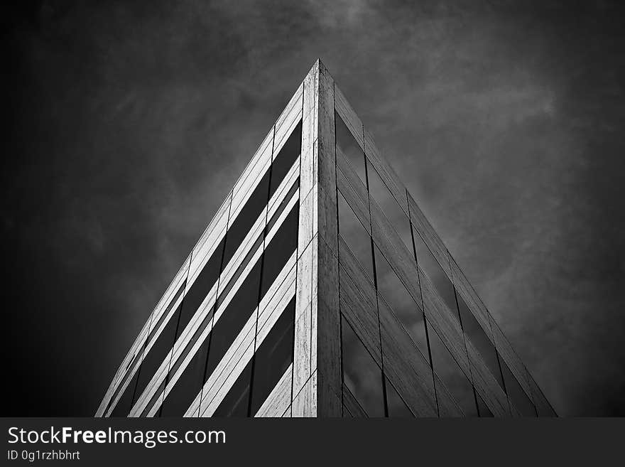 A low angle perspective view of the corner of a building in monochrome.