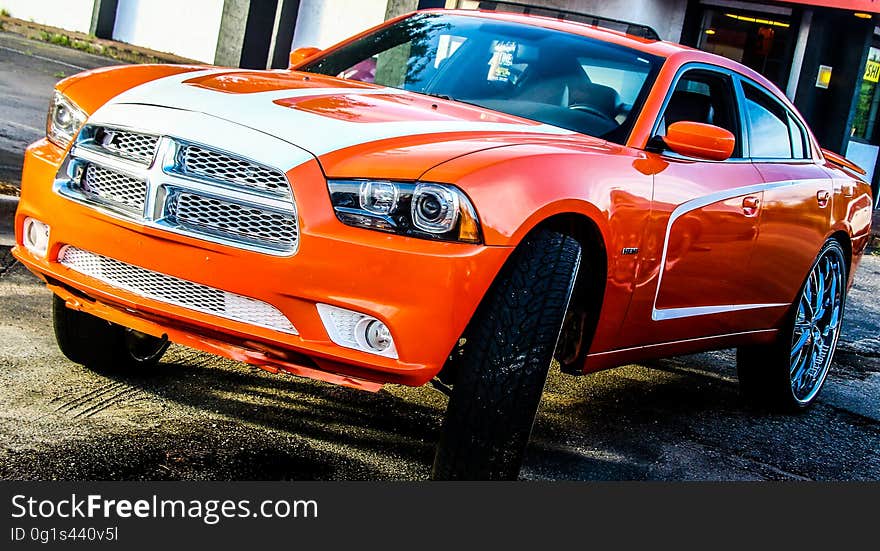 A close up of an orange muscle car.