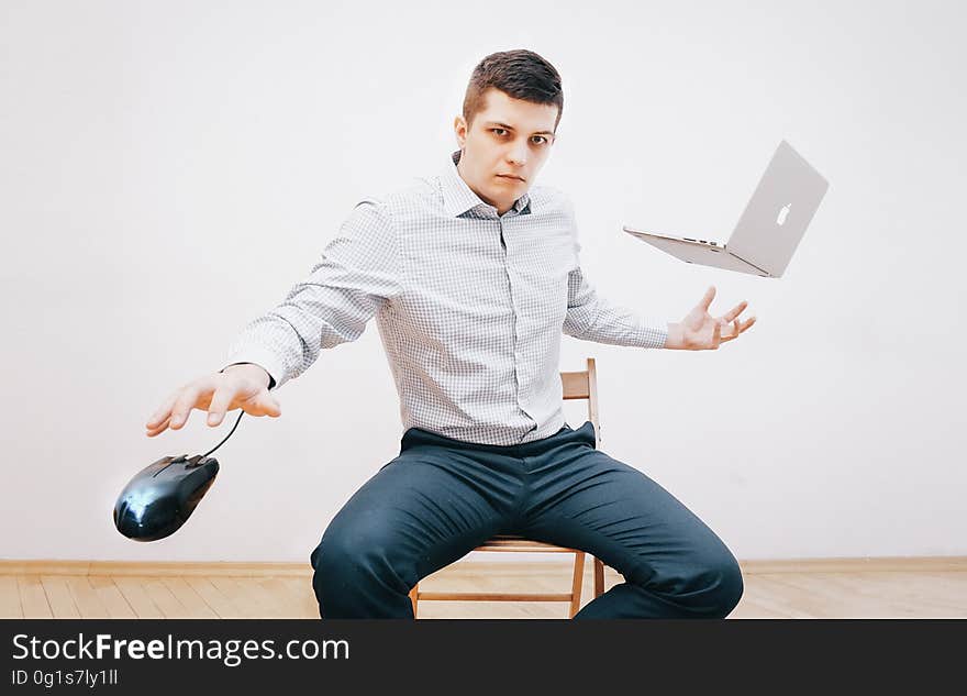 Man in Gray Dress Shirt and Making Tricks