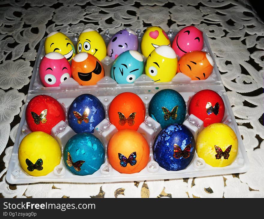 Decorated Easter eggs on table with white tablecloth