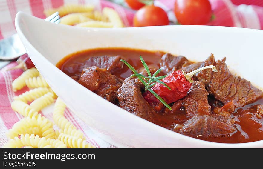 A bowl of beef stew with chili. A bowl of beef stew with chili.