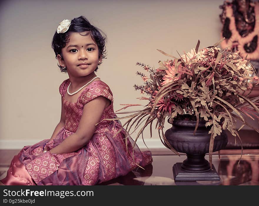 Girl Beside Flower Vase Inside White Painted Room