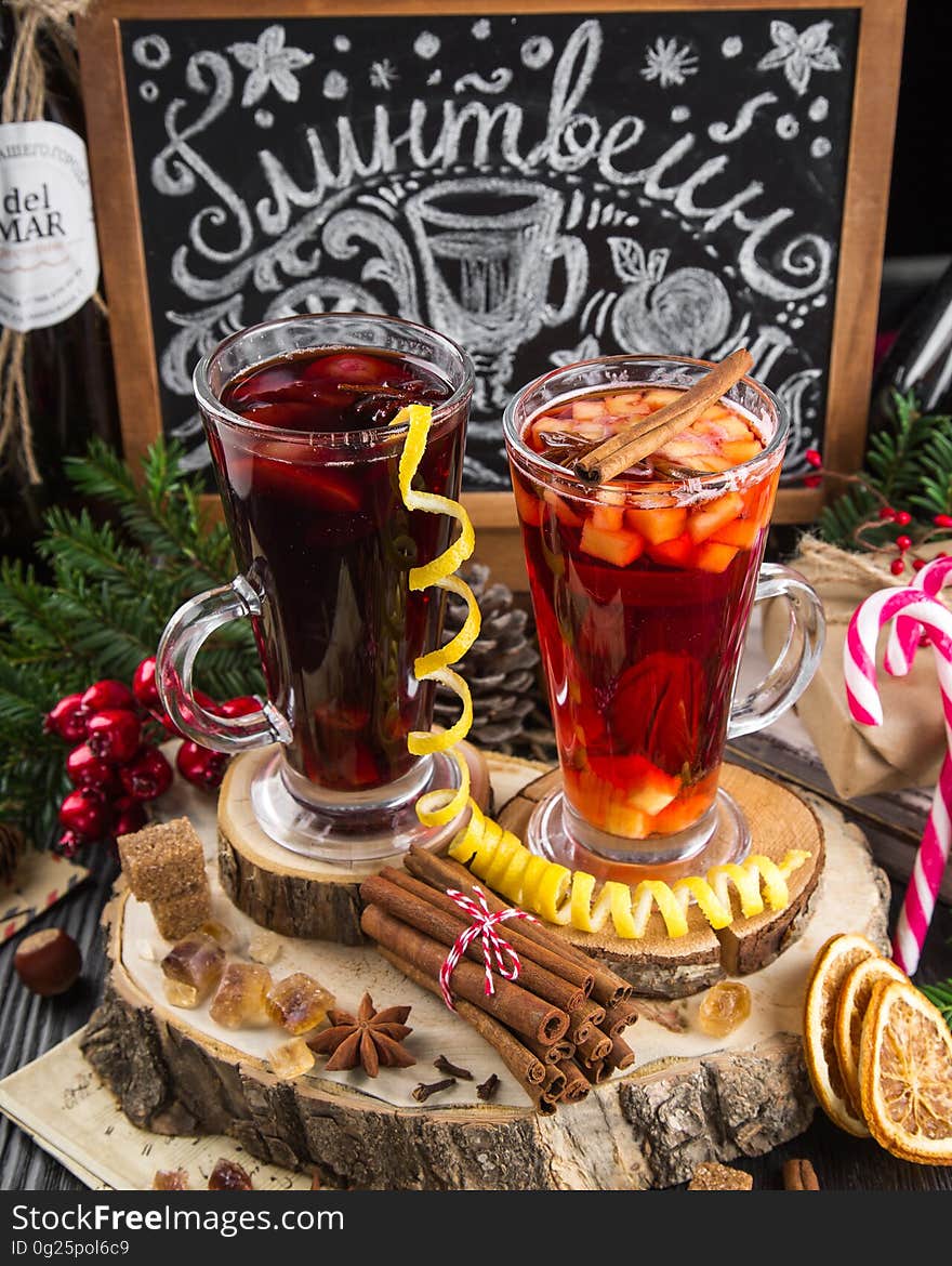 Two glasses with mulled wine on a table with Christmas decorations.