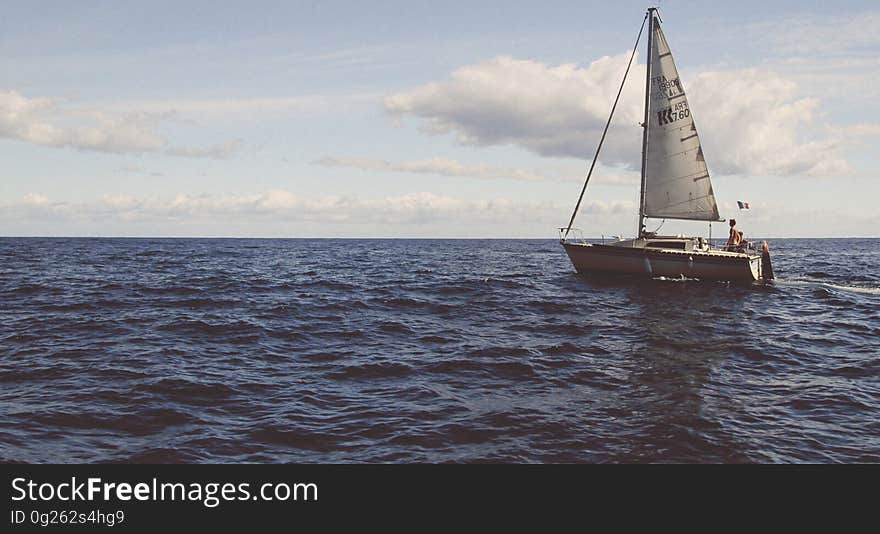 Scenic view of yacht sailing in the Mediterranean sea, cloudscape background.