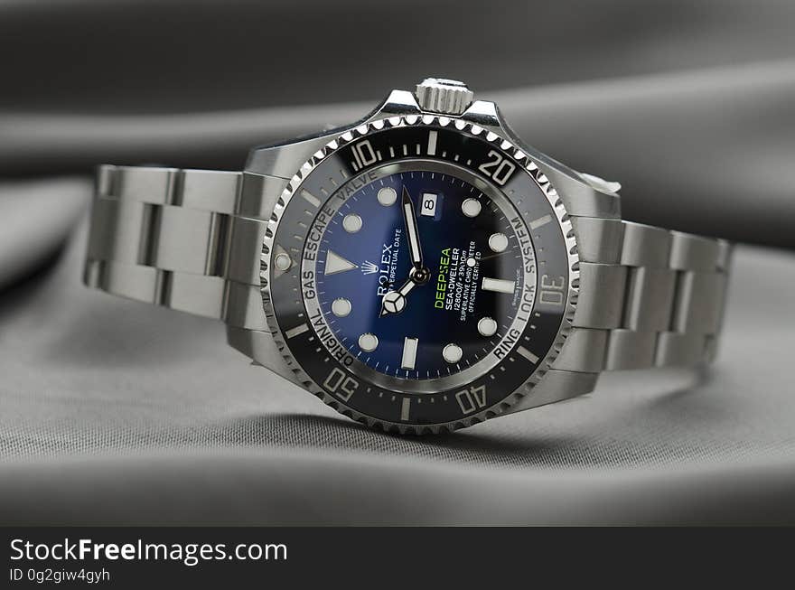 Blue face on grey metal Rolex wristwatch. Blue face on grey metal Rolex wristwatch.