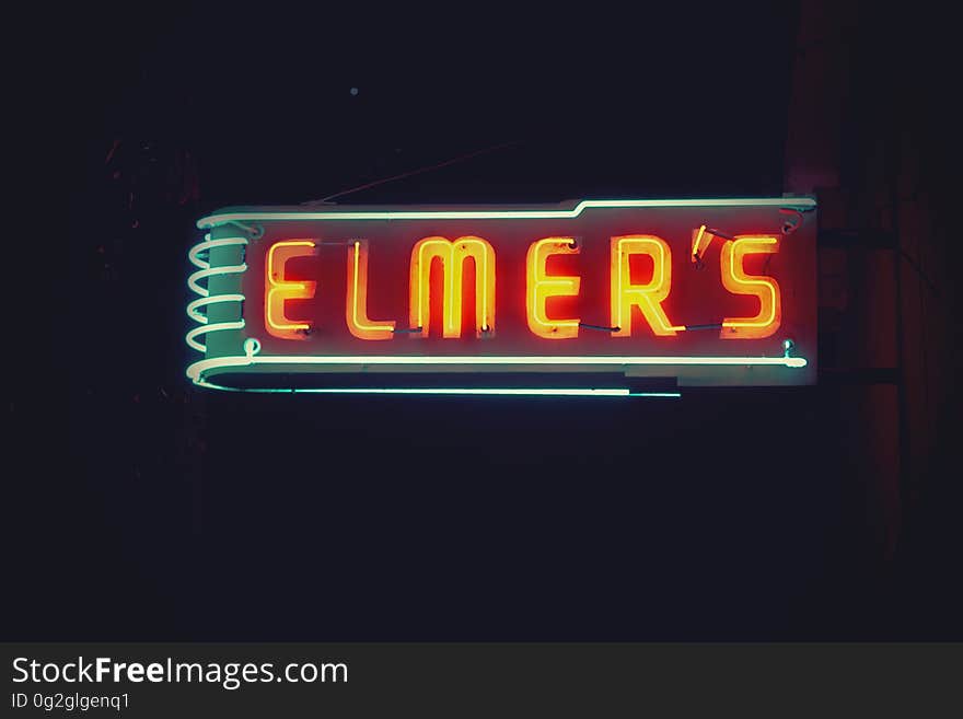 A bar or a diner with a neon sign in the night.