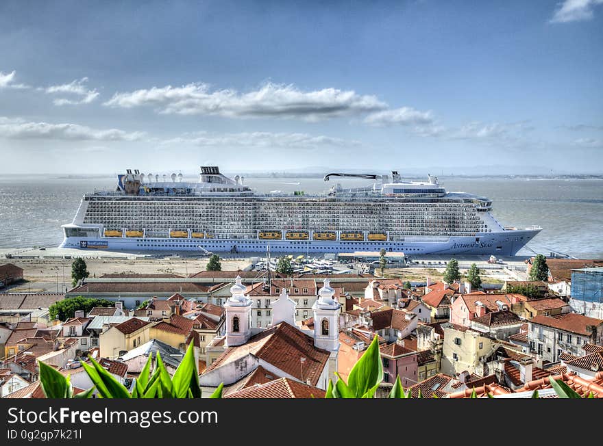 Cruise ship just offshore of beach next to small town. Cruise ship just offshore of beach next to small town.