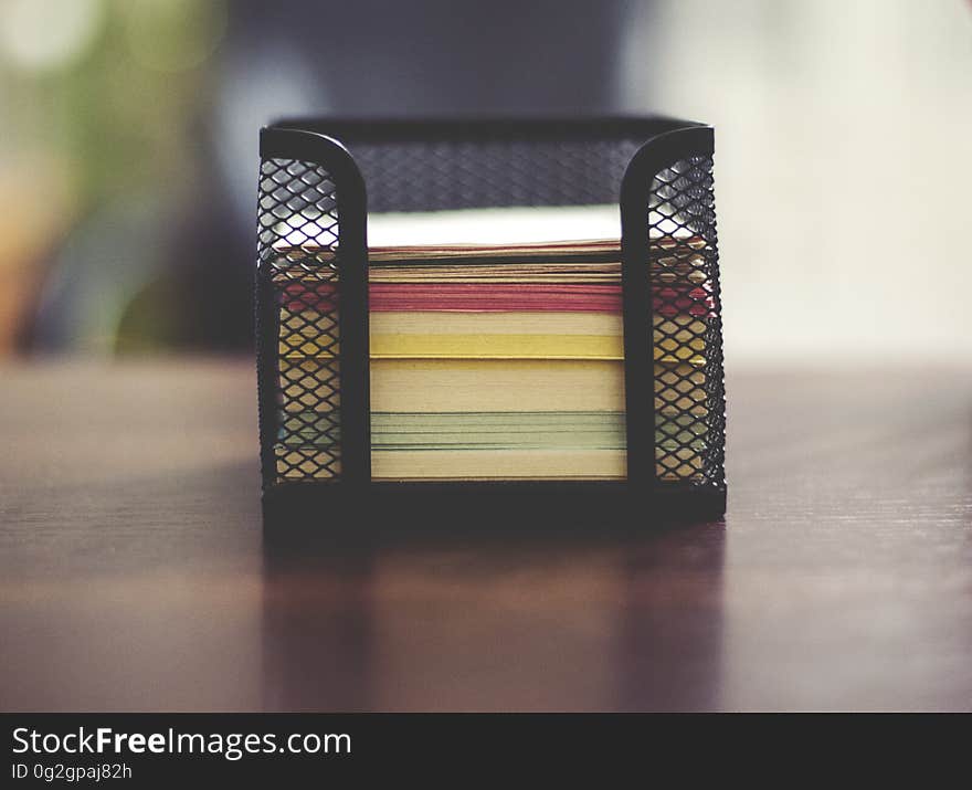 Close up of metal container with colorful sheets of notepaper. Close up of metal container with colorful sheets of notepaper.