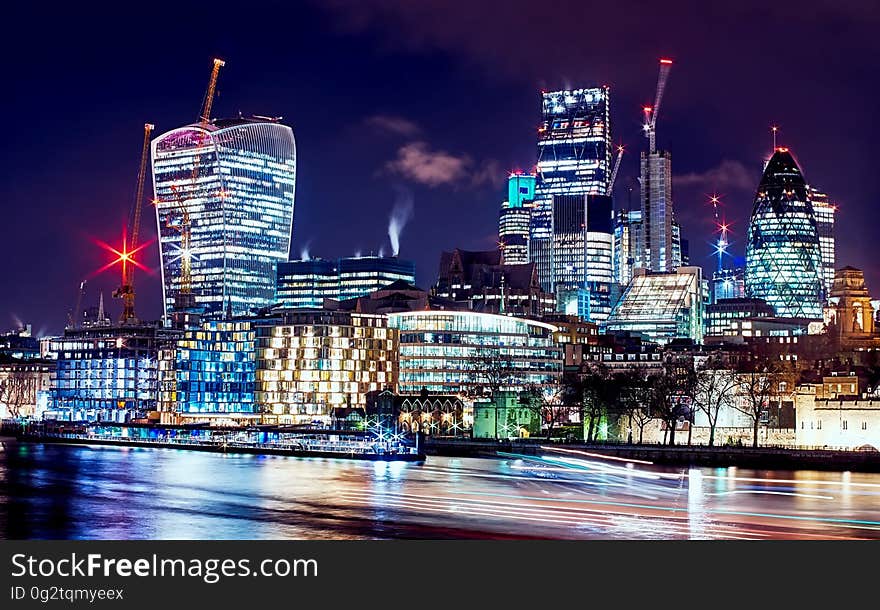 Waterfront skyline illuminated at night.