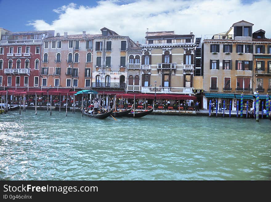 The water streets of Venice are canals which are navigated by gondolas and other small boats. During daylight hours the canals, bridges, and streets of Venice are full of tourists eager to experience the romance of this great travel destination. As night engulfs the town, tourists enjoy some fine dining at one of the many restaurants, leaving the waterways and streets quiet. The gondola is a traditional, flat-bottomed Venetian rowing boat, well suited to the conditions of the Venetian Lagoon. For centuries gondolas were once the chief means of transportation and most common watercraft within Venice. In modern times the iconic boats still have a role in public transport in the city, serving as ferries over the Grand Canal. They are also used in special regattas &#x28;rowing races&#x29; held amongst gondoliers. Their main role, however, is to carry tourists on rides throughout the canals. Gondolas are hand made using 8 different types of wood &#x28;fir, oak, cherry, walnut, elm, mahogany, larch and lime&#x29; and are composed of 280 pieces. The oars are made of beech wood. The left side of the gondola is longer than the right side. This asymmetry causes the gondola to resist the tendency to turn toward the left at the forward stroke. The water streets of Venice are canals which are navigated by gondolas and other small boats. During daylight hours the canals, bridges, and streets of Venice are full of tourists eager to experience the romance of this great travel destination. As night engulfs the town, tourists enjoy some fine dining at one of the many restaurants, leaving the waterways and streets quiet. The gondola is a traditional, flat-bottomed Venetian rowing boat, well suited to the conditions of the Venetian Lagoon. For centuries gondolas were once the chief means of transportation and most common watercraft within Venice. In modern times the iconic boats still have a role in public transport in the city, serving as ferries over the Grand Canal. They are also used in special regattas &#x28;rowing races&#x29; held amongst gondoliers. Their main role, however, is to carry tourists on rides throughout the canals. Gondolas are hand made using 8 different types of wood &#x28;fir, oak, cherry, walnut, elm, mahogany, larch and lime&#x29; and are composed of 280 pieces. The oars are made of beech wood. The left side of the gondola is longer than the right side. This asymmetry causes the gondola to resist the tendency to turn toward the left at the forward stroke.