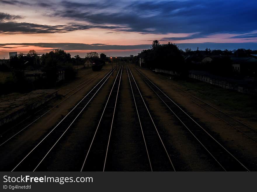 A railroad with four tracks at dusk. A railroad with four tracks at dusk.