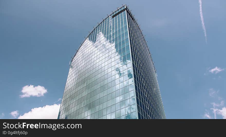 A skyscraper with glass facade against the blue skies. A skyscraper with glass facade against the blue skies.