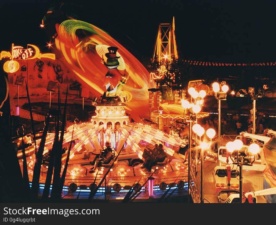 Blur of lights on ride in amusement park at night.