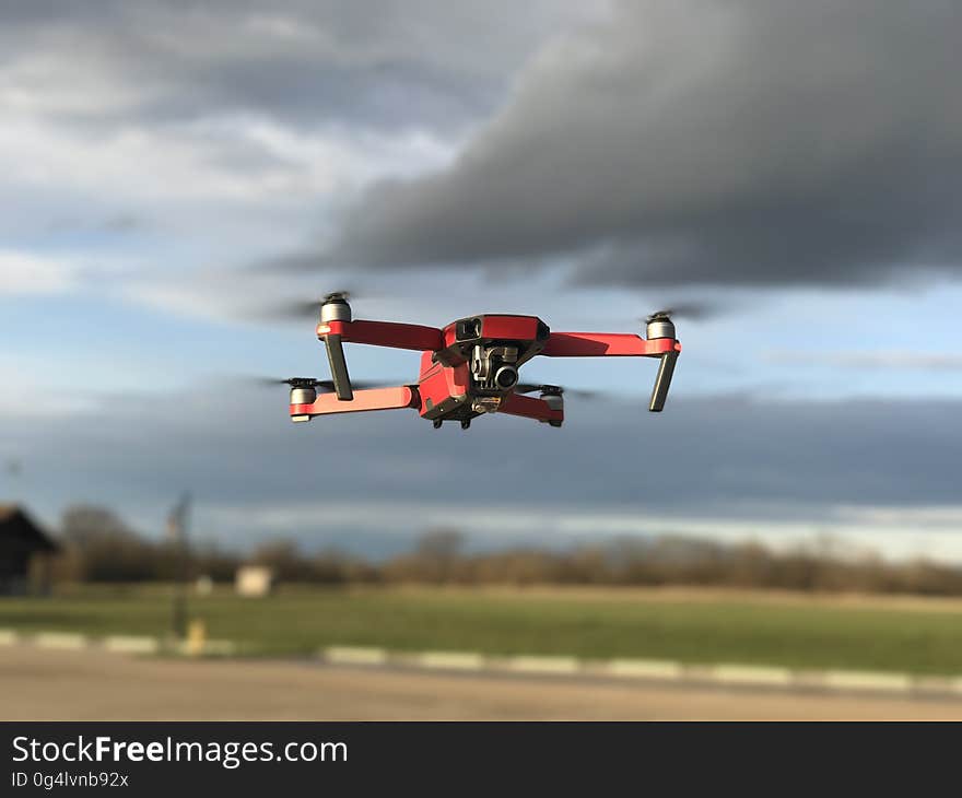 Drone flying against grey clouds in sky. Drone flying against grey clouds in sky.