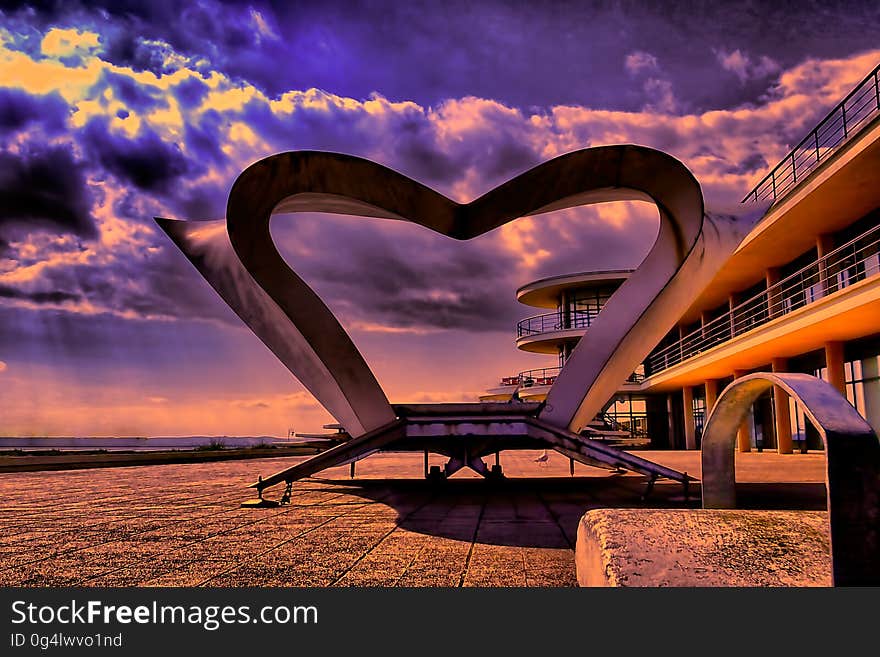 Modern sculpture outside contemporary building at sunset. Modern sculpture outside contemporary building at sunset.