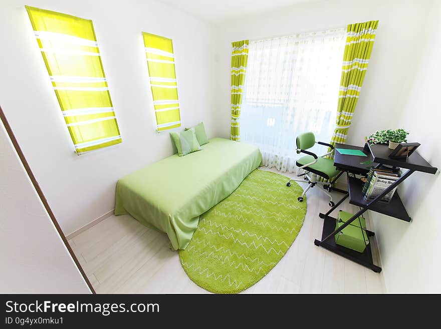 Interior of apartment bedroom decorated in green.