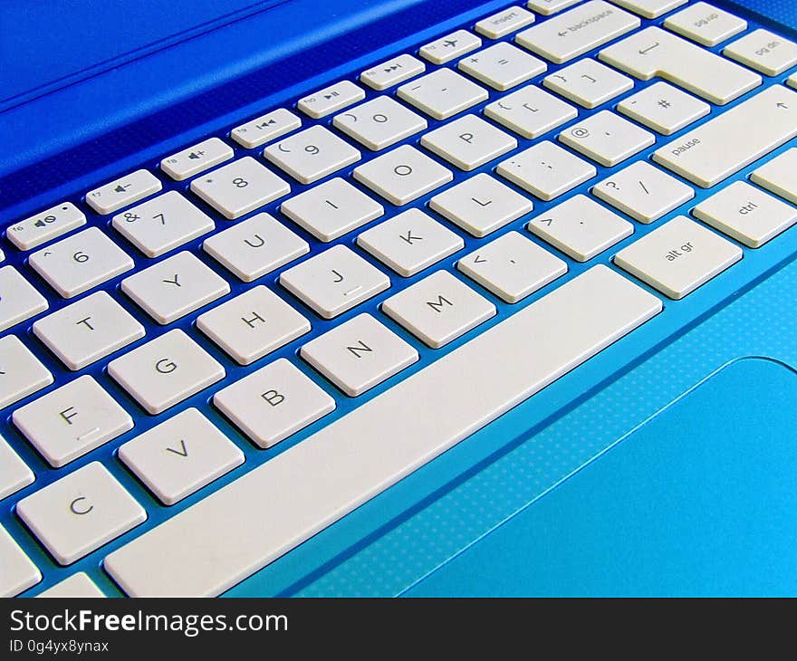 Close up of keyboard on blue laptop computer. Close up of keyboard on blue laptop computer.