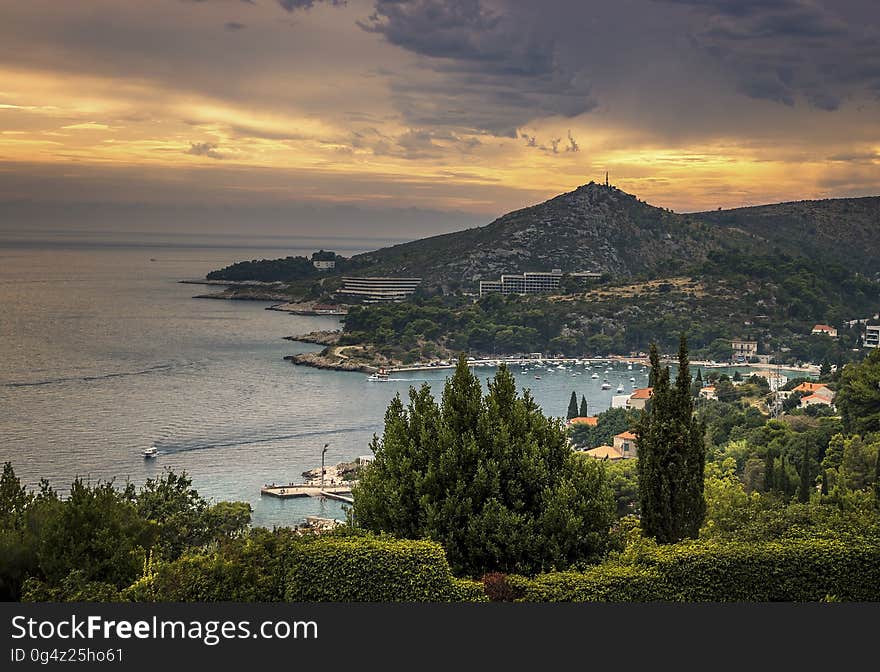 Aerial view of coastal village in hills at sunrise. Aerial view of coastal village in hills at sunrise.