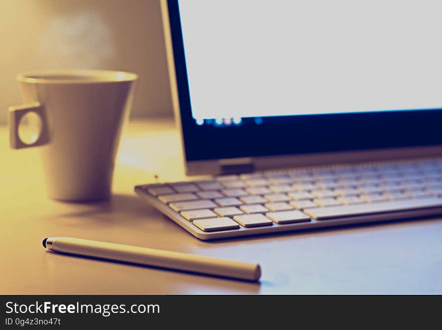 Computer with keyboard, pen and cup of coffee on desktop. Computer with keyboard, pen and cup of coffee on desktop.