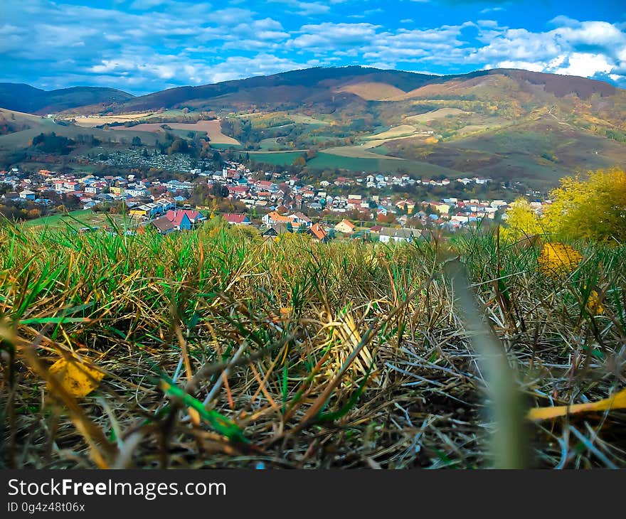 A view of a village in a valley and hillside in the background. A view of a village in a valley and hillside in the background.