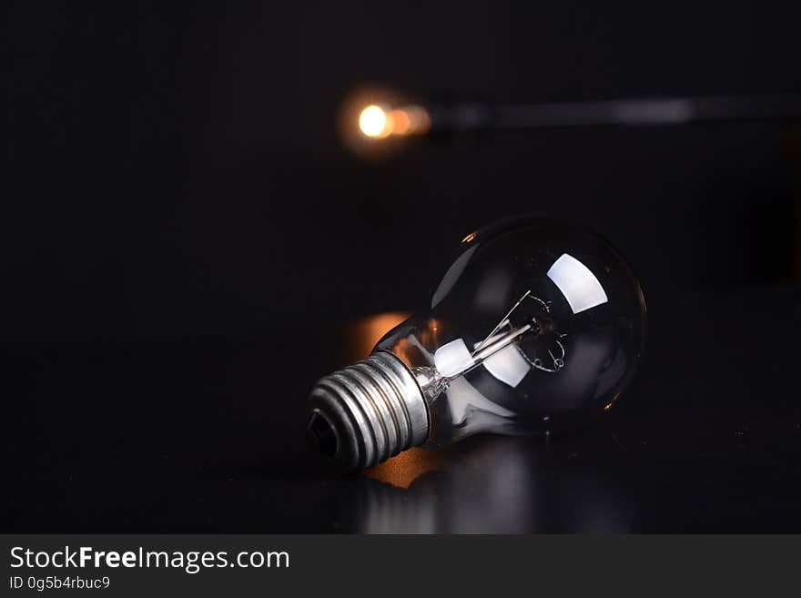 Close up of light bulb with bokeh lights in background.