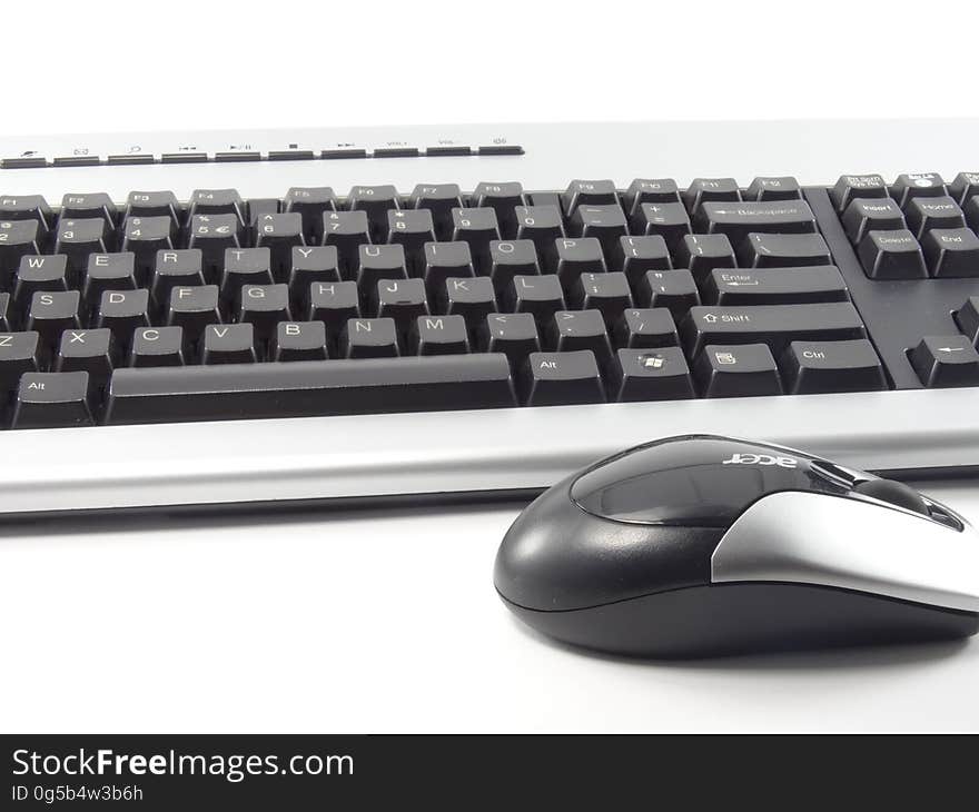 Close up of computer keyboard and mouse in black and white.