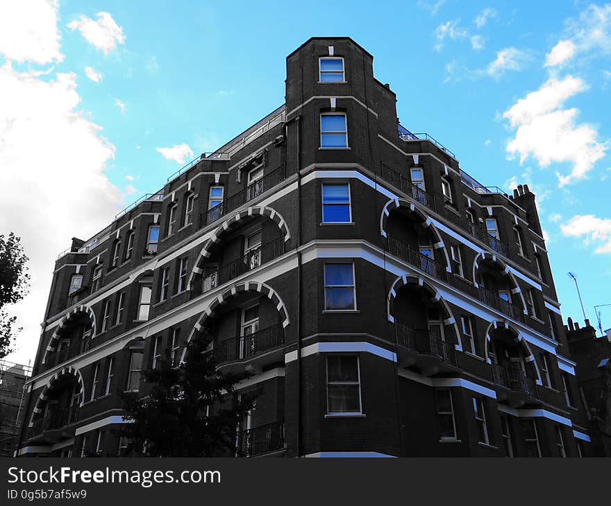 A modern building with arches above balconies. A modern building with arches above balconies.