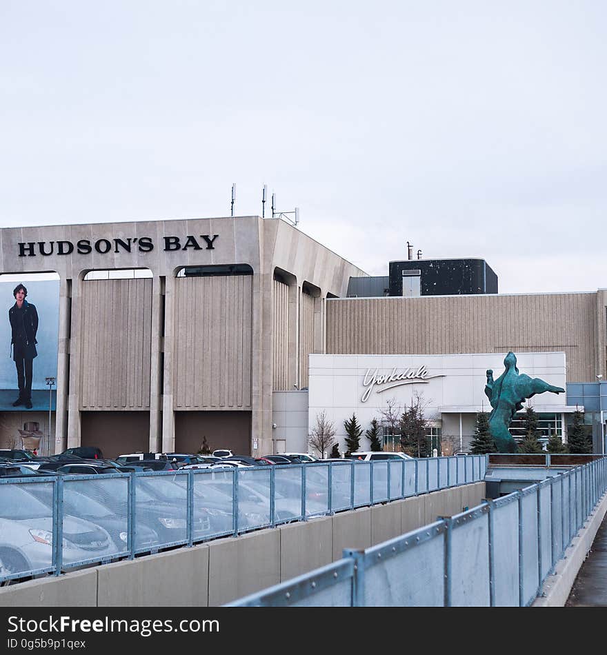 Exterior of Hudson's Bay museum with cars in parking lot on sunny day. Exterior of Hudson's Bay museum with cars in parking lot on sunny day.