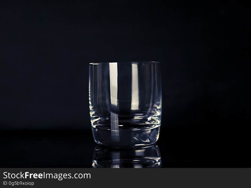 Light reflecting on crystal drinking glass against black. Light reflecting on crystal drinking glass against black.