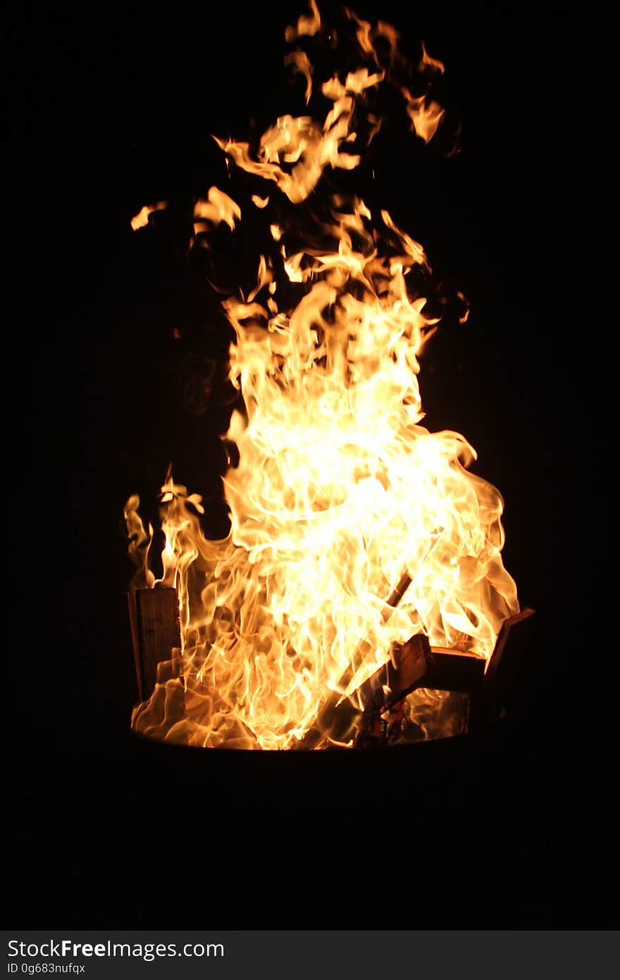 A bonfire burning at night.