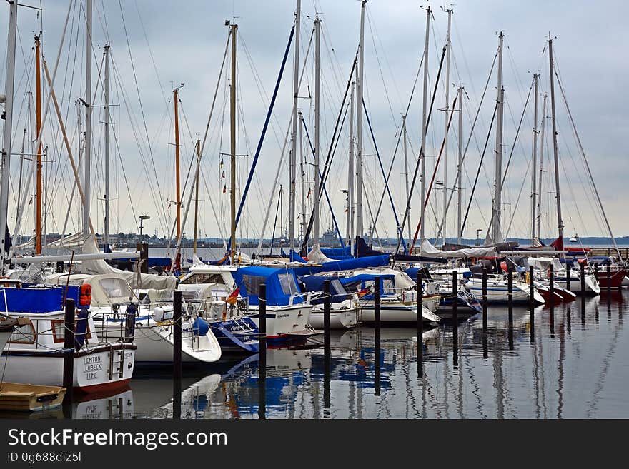 Sailboats docked in the marina in the evening. Sailboats docked in the marina in the evening.