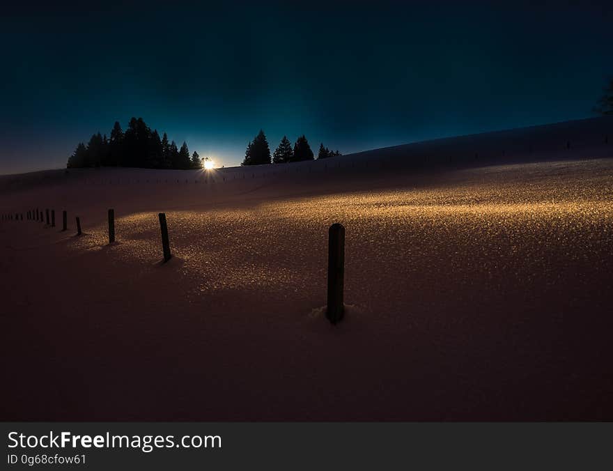 A field with lights at sunset. A field with lights at sunset.