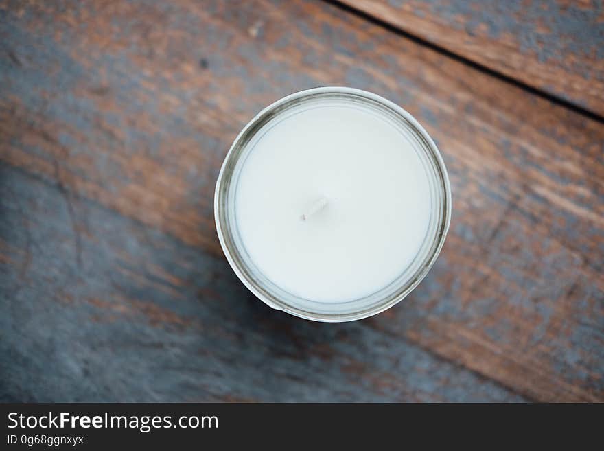 Overhead view of drink of milk on rustic wooden table. Overhead view of drink of milk on rustic wooden table.